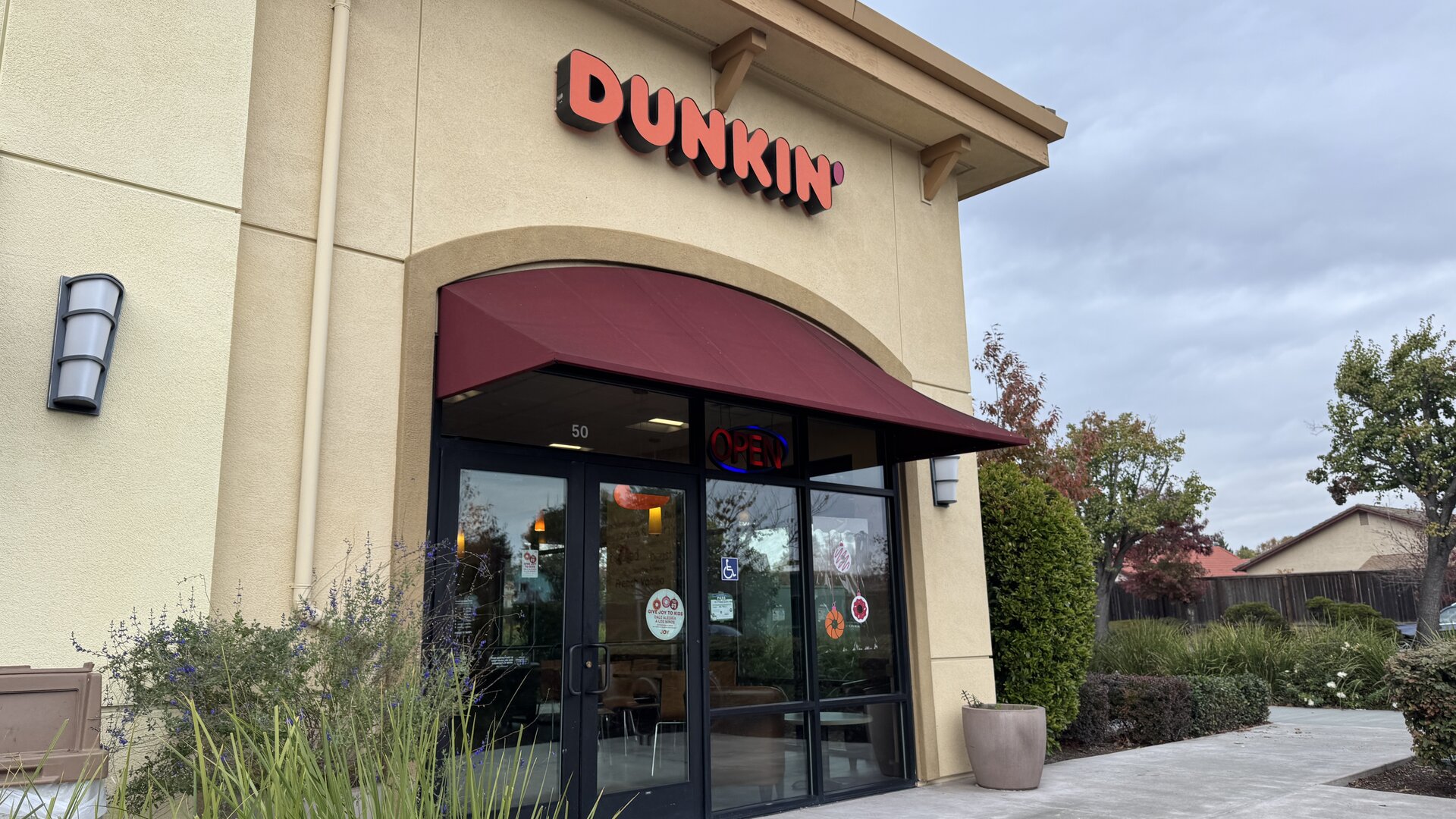 A Dunkin' Donuts storefront photographed at street level.