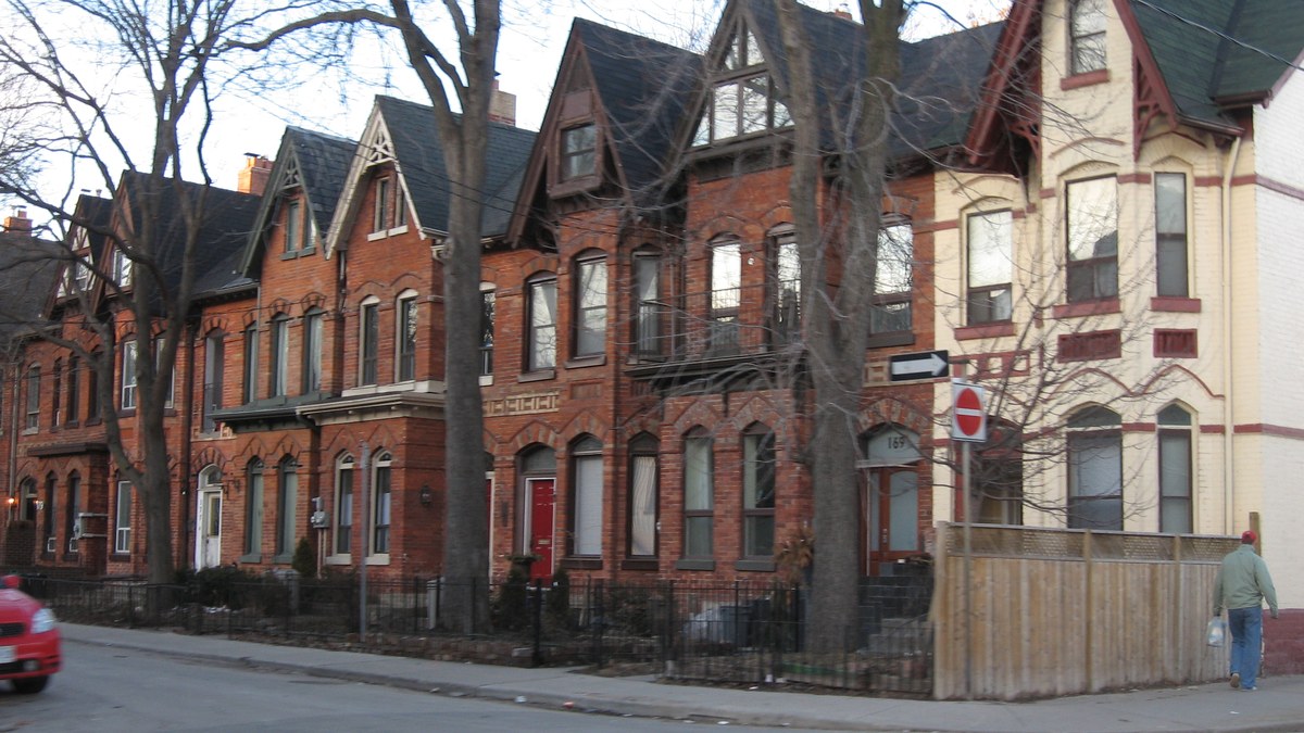 A row of Victorian-era Toronto row houses on a residential street — the housing stock millennials cannot afford